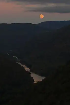 moon over a deep river gorge